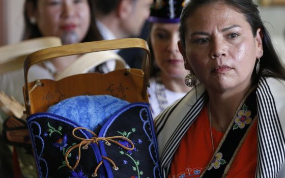 An Indigenous woman displays a cradleboard as Pope Francis meets with a delegation of Indigenous peoples in the archbishop's residence in Quebec City July 29, 2022. (CNS photo/Paul Haring)
