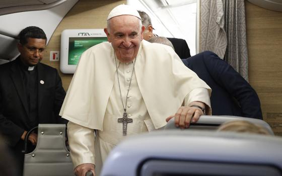Pope Francis arrives to answer questions from journalists aboard his flight from Iqaluit, in the Canadian territory of Nunavut, to Rome July 29. (CNS/Paul Haring)