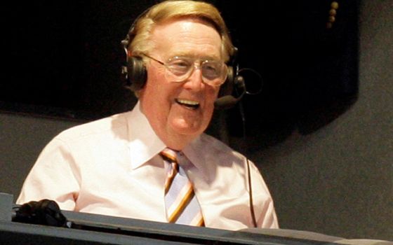 Legendary Los Angeles Dodgers announcer Vin Scully smiles in a broadcast booth during the National League MLB baseball game between the San Francisco Giants and the Los Angeles Dodgers in Los Angeles, April 25, 2007