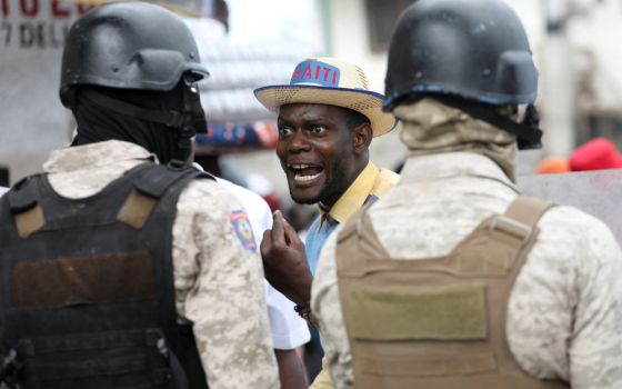 A demonstrator shouts at police during protests demanding that the government of Haitian Prime Minister Ariel Henry do more to address gang violence, including constant kidnappings, in Port-au-Prince March 29, 2022. 