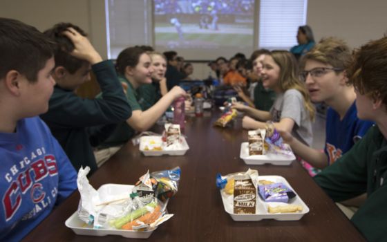 Students at Holy Name of Jesus Catholic School in Henderson, Ky., eat lunch and watch the opening day of Major League Baseball March 29, 2018. (CNS photo/Tyler Orsburn)