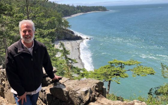 John Mundell poses for a photo against the backdrop of the Puget Sound in the state of Washington. In July, the Vatican Dicastery for Promoting Integral Human Development announced Mundell as director of the Laudato Si' Action Platform. (CNS photo)