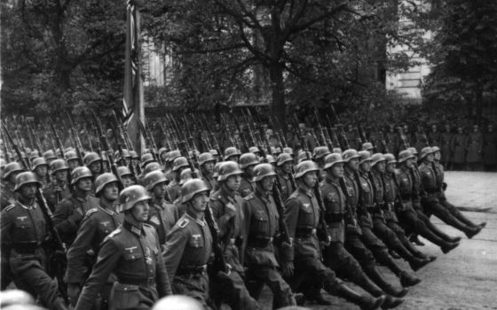 Black and white photo of German troops marching through Warsaw, Poland, in September 1939.