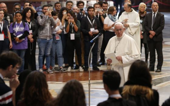 Pope Francis prepares to address young people who participated in a pilgrimage hike from the Monte Mario nature reserve in Rome to St. Peter's Basilica at the Vatican Oct. 25, 2018, during the Synod of Bishops on young people, the faith and vocational dis