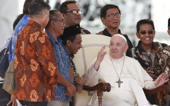 Pope Francis meets Jesuit priests from Indonesia during his general audience in St. Peter's Square at the Vatican Sept. 21, 2022.