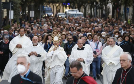 People participate in a eucharistic procession during Italy's National Eucharistic Congress in Matera, Italy, Sept. 24, 2022. 