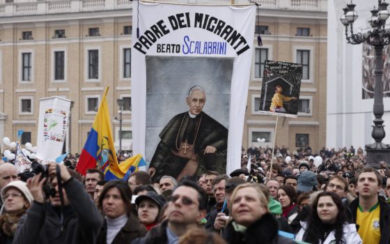 A banner honoring Blessed Giovanni Battista Scalabrini is seen as Pope Benedict XVI leads the Angelus at the Vatican in this Jan. 17, 2010, file photo. (CNS photo/Paul Haring)
