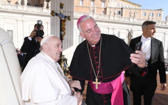 Archbishop Nelson J. Pérez of Philadelphia takes a selfie with Pope Francis at the end of the pope's weekly general audience in St. Peter's Square Oct. 12, 2022