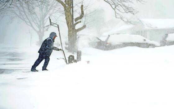 Brian Rhodes uses a snow blower to clear his driveway in Stony Brook, N.Y., during a blizzard that swept through parts of the Northeast U.S. Jan. 29, 2022. (CNS/Gregory A. Shemitz)