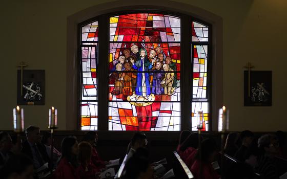 A stained-glass window depicting the descent of the Holy Spirit upon Mary and the apostles is seen during a confirmation Mass May 5, 2022, at Holy Family Church in Queens, New York. (CNS/Gregory A. Shemitz)