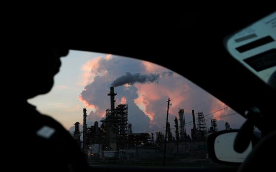 A police officer in in Pasadena, Texas, drives past a refinery Sept. 18, 2018. (CNS/Reuters/Loren Elliott)