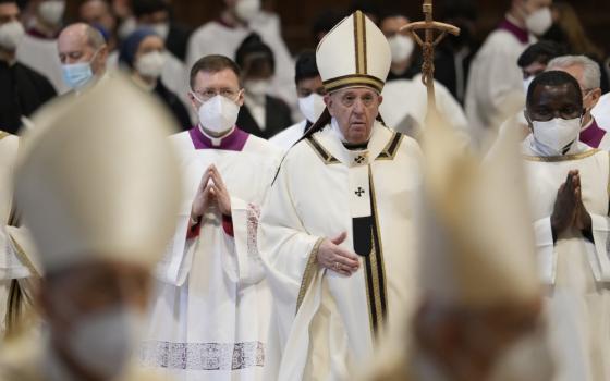 Pope Francis walks with his pastoral staff among cardinals and prelates at the end of an Epiphany Mass in St. Peter's Basilica at the Vatican, Jan. 6, 2022. (AP/Gregorio Borgia)