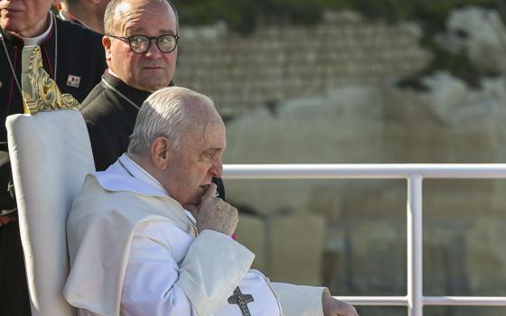 Pope Francis sits next to Maltese Archbishop Charles Scicluna, left, aboard a catamaran leaving Valletta's harbor for Gozo in Malta during a papal trip April 2, 2022. (Andreas Solaro/Pool via AP)