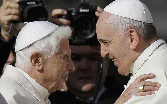 On Sept. 28, 2014, Pope Francis, right, hugs Emeritus Pope Benedict XVI prior to the start of a meeting with elderly faithful in St. Peter's Square at the Vatican. (AP/Gregorio Borgia, File)