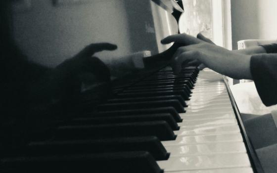 close-up of hands on a piano