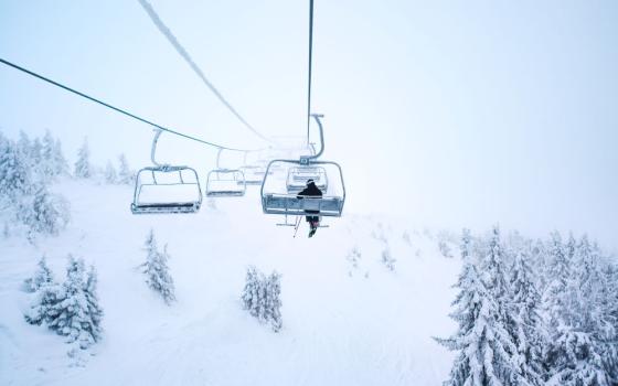 ski lift above snowy hills