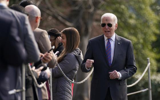 President Joe Biden greets visitors upon his departure from the White House on Ash Wednesday in Washington March 2, 2022. (CNS photo/Kevin Lamarque, Reuters)