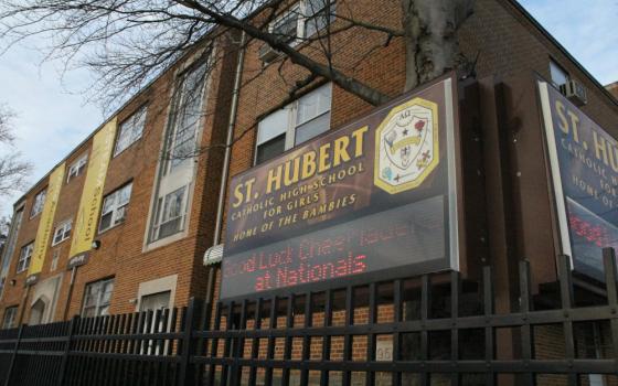 A brown brick building with a "St. Hubert Catholic High School for Girls Home of the Bambies" sign out front