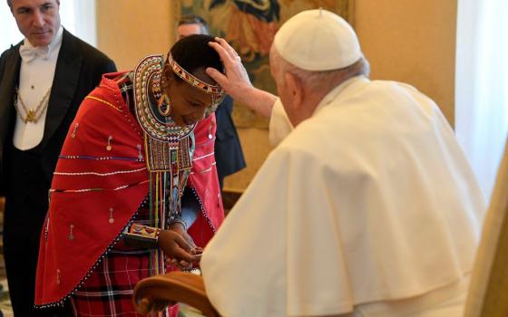 Pope Francis blesses a participant from the International Fund for Agricultural Development's Indigenous Peoples' Forum during an audience at the Vatican Feb. 10, 2023. (CNS photo/Vatican Media)