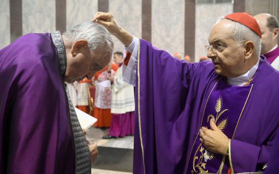 Cardinal Mauro Piacenza, head of the Apostolic Penitentiary, sprinkles ashes on the head of Pope Francis during Ash Wednesday Mass at the Basilica of Santa Sabina in Rome Feb. 22, 2023. (CNS photo/Vatican Media)