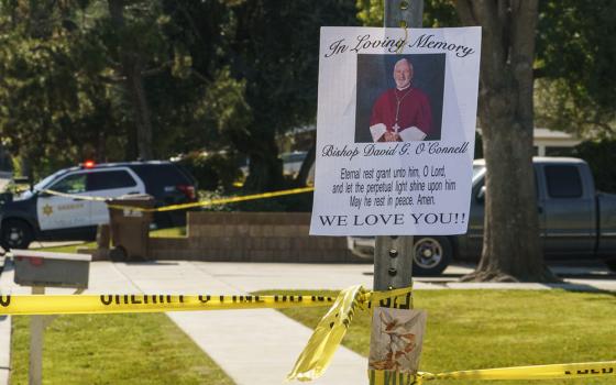 An image of Los Angeles Auxiliary Bishop David O'Connell is seen on the post of a street sign near his home in Hacienda Heights, California, Feb. 19. (AP/Damian Dovarganes)