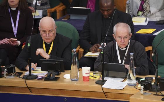 The Archbishop of York, Stephen Cottrell, left and The Archbishop of Canterbury, Justin Welby, gather at the General Synod of the Church of England, at Church House to consider a motion which reviews the church's failure "to be welcoming to LGBTQI+ people" and the harm they have faced and still experience, in London, Thursday, Feb. 9, 2023. (James Manning/PA via AP)