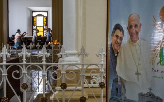 A poster of Pope Francis and Bishop Rolando Alvarez stands outside a sanctuary
