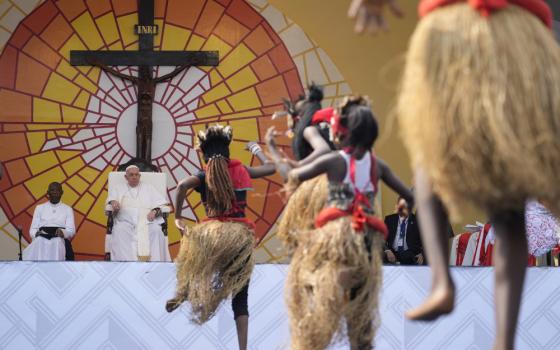 Pope Francis, second from left, watches traditional dancers perform at the Martyrs' Stadium in Kinshasa, Democratic Republic of the Congo Feb. 2. (AP/Gregorio Borgia)