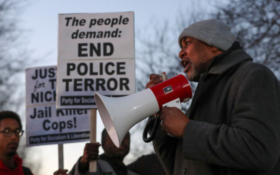 A man speaks through a bullhorn during a protest in Memphis, Tennessee, Jan. 27, on the day of the release of the video showing police officers beating Tyre Nichols, the young Black man who was killed as a result of a traffic stop by Memphis police officers. (OSV News/Reuters/Alyssa Pointer)