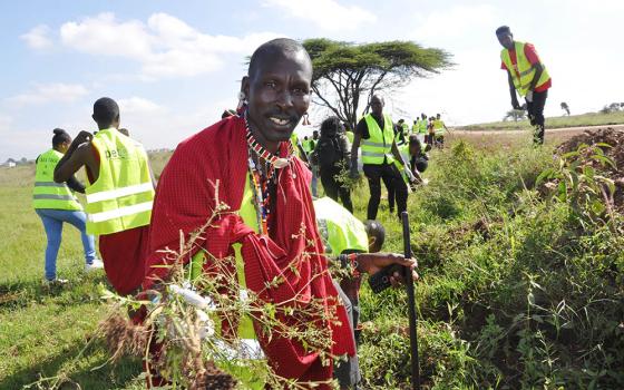 Amos Kwaite, a member of the Maasai community, joins Kenyans including members of the Laudato Si' Movement in a cleanup of Nairobi National Park June 4, 2022, as part of the observance of World Environment Day. (CNS/Fredrick Nzwili)