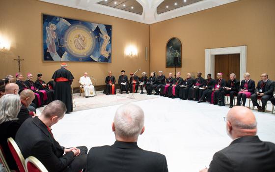 Pope Francis listens as Cardinal Jean-Claude Hollerich of Luxembourg, relator general of the Synod of Bishops, speaks during a meeting with the presidents and coordinators of the regional assemblies of the Synod of Bishops at the Vatican Nov. 28, 2022. (CNS/Vatican Media)