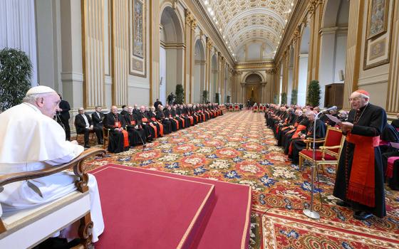 Pope Francis listens as Cardinal Giovanni Battista Re, dean of the College of Cardinals, offers best wishes for Christmas on behalf of the cardinals and top officials of the Roman Curia during a gathering Dec. 22, 2022, in the Vatican's Hall of Blessings. (CNS/Vatican Media)