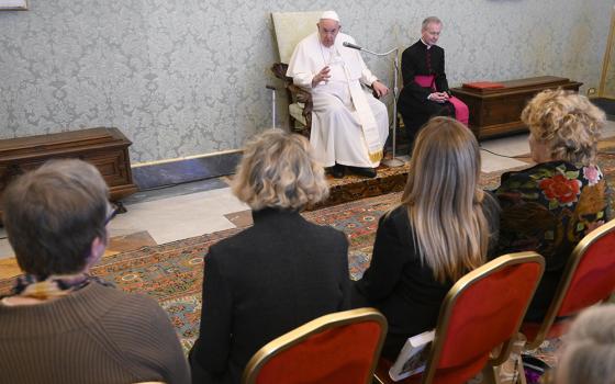 Pope Francis speaks with staff members of the Vatican newspaper's monthly insert dedicated to women during an audience March 4 at the Vatican. The supplement, "Women, church, world," was launched in May in 2012. The pope praised and encouraged them in their work, saying "it is not a kind of clerical feminism of the pope, no! It is opening the door to a reality, a reflection that goes deeper." (CNS/Vatican Media)