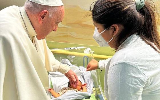Pope Francis comforts Miguel Angel after baptizing the baby boy in Rome's Gemelli hospital March 31, 2023. The pope spent about half an hour in the hospital's pediatric oncology ward the afternoon before he was scheduled to be released from Gemelli after being treated for bronchitis. (CNS photo/Holy See Press Office)