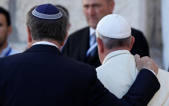 Rabbi Abraham Skorka and Pope Francis embrace after visiting the Western Wall in Jerusalem May 26, 2014. They have been friends for 25 years and co-authored "On Heaven and Earth" in 2010. (CNS photo/Paul Haring)