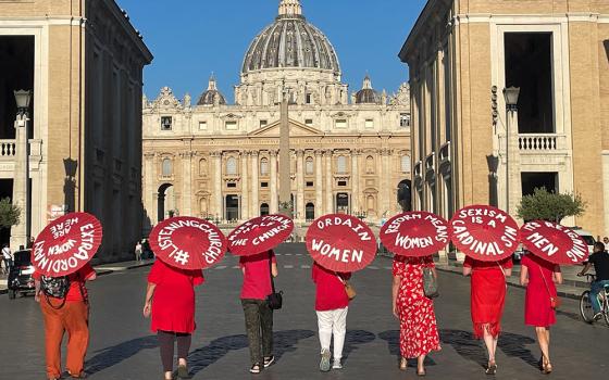 Women's ordination advocates walk toward St. Peter's Square at the Vatican as part of a witness on Aug. 29, 2022. (NCR photo/Christopher White)