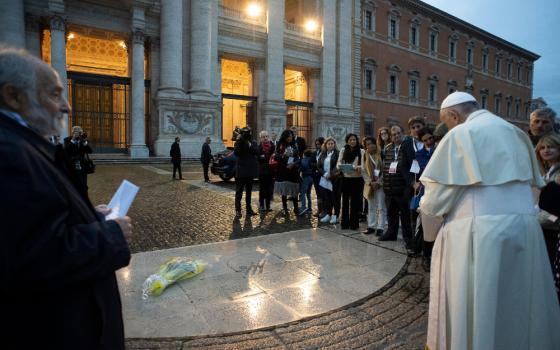 ope Francis dedicates a plaque before celebrating Mass at the Basilica of St. John Lateran in Rome Nov. 11, 2019. The plaque commemorates those who have died in the city because of poverty and neglect. (CNS photo/Vatican Media)