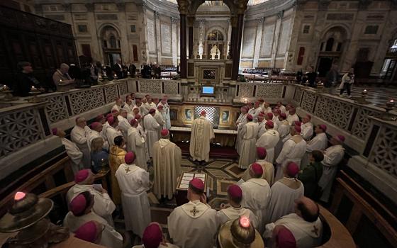 Members of the German bishops' conference pray before the tomb of St. Paul Nov. 17, 2022, during an "ad limina" visit to Rome's Basilica of St. Paul Outside the Walls. (CNS/Deutsche Bischofskonferenz/Daniela Elpers)