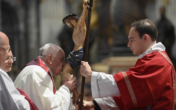Pope Francis kisses a crucifix during the Good Friday Liturgy of the Lord's Passion in St. Peter's Basilica at the Vatican April 7, 2023. (CNS photo/Vatican Media)