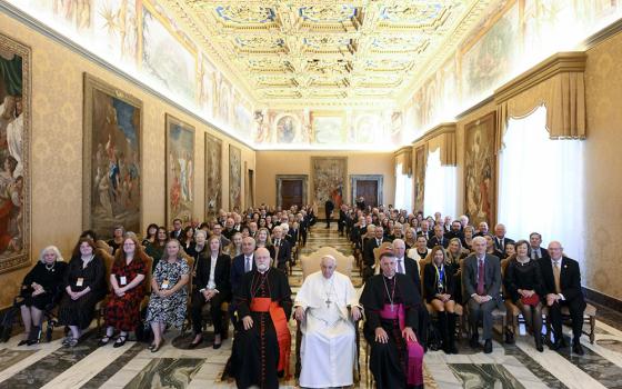 Pope Francis poses for a photo with members of the U.S.-based Papal Foundation during an audience at the Vatican April 21. The pope is seated between Boston Cardinal Sean O'Malley, chair of the foundation's board of trustees, and Bishop James Checchio of Metuchen, New Jersey. (CNS/Vatican Media)