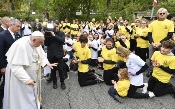 Pope Francis greets about 100 children and young people who gathered outside the Church of St. Laszlo in Budapest, Hungary, to pray for Pope Francis April 29, 2023. (CNS photo/Vatican Media)