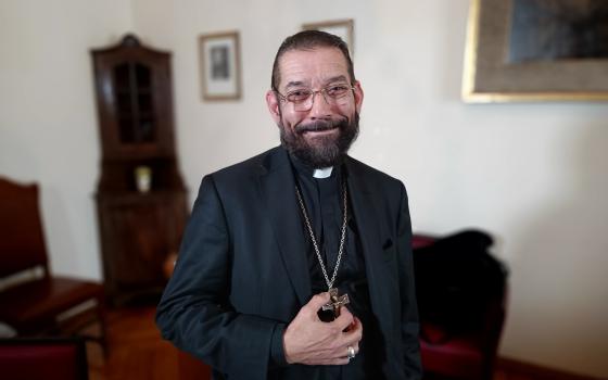 Bishop Daniel E. Flores of Brownsville, Texas, poses for a photo in the offices of the General Secretariat of the Synod at the Vatican April 12. 