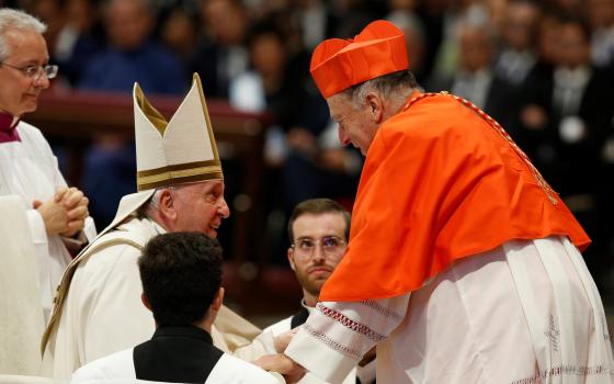 Pope Francis talks with San Diego Cardinal Robert McElroy after presenting the red biretta to him during a consistory for the creation of 20 new cardinals in St. Peter's Basilica at the Vatican Aug. 27, 2022. (CNS/Paul Haring)