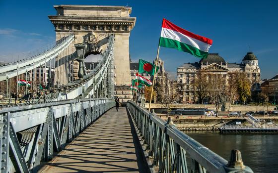 A pedestrian crosses Széchenyi Chain Bridge in Budapest, Hungary, in a 2016 file photo. (Wikimedia Commons/Jorge Franganillo)