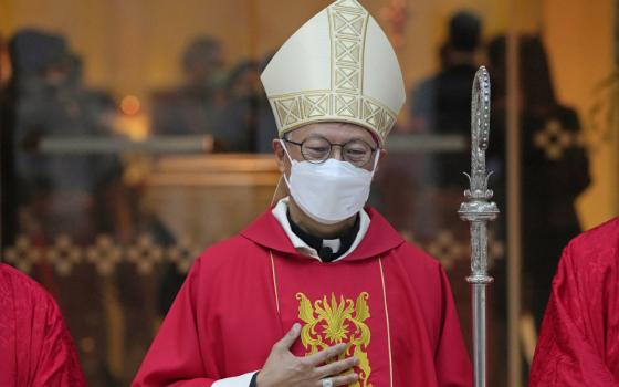 Stephen Chow wearing a surgical mask to protect against the coronavirus, poses after the episcopal ordination ceremony as the new Bishop of the Catholic Diocese, in Hong Kong, Dec. 4, 2021. The Hong Kong's Roman Catholic bishop arrived in Beijing on Monday, April 17, 2023, marking the first visit to the Chinese capital by the city's bishop in nearly three decades, despite signs of Sino-Vatican strains.(AP Photo/Kin Cheung, File)