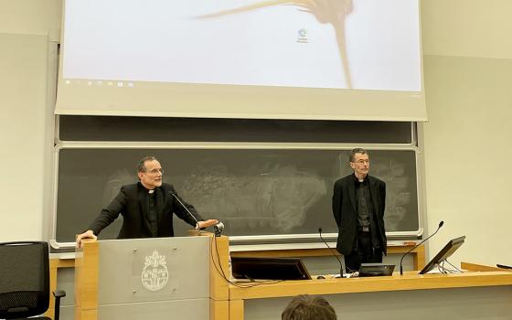 German Jesuit Fr. Philip Renczes, left, presents next year's seminar offerings for the newly launched ecumenical studies program at the Pontifical Gregorian University in Rome. (NCR photo/Christopher White)