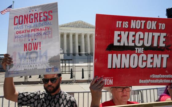 Demonstrators hold signs protesting capital punishment in front of the U.S. Supreme Court building in Washington, June 29, 2022. (OSV News/Reuters/Kevin Lamarque)