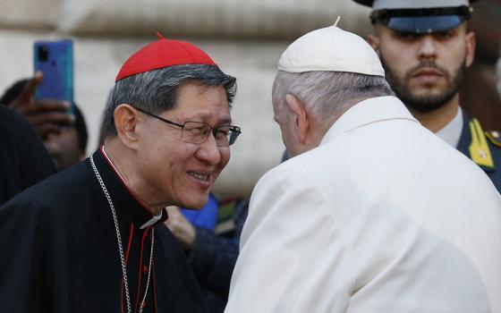Pope Francis talks with Cardinal Luis Antonio Tagle after praying in front of a Marian statue at the Spanish Steps in Rome Dec. 8, 2022, the feast of the Immaculate Conception. (CNS/Paul Haring)