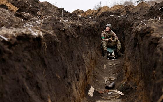 A Ukrainian soldier listens to artillery fire from his bunker at a front-line position near Bakhmut March 16, amid Russia's attack on Ukraine. (OSV News photo/Reuters/Violeta Santos Moura)