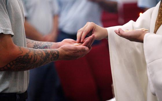 A file photo shows an inmate receiving Communion at the Ellsworth Correctional Facility in Kansas. (OSV News/CNS file/The Register/Karen Bonar)